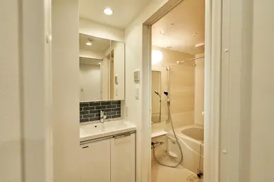 a white bathroom with a sink and a shower at livecasa\u8535\u524d brand-new hotel, a 3-minute walk from Asakusa Kuramae Statio in Tokyo