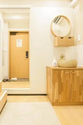 a bathroom with a mirror and a wooden door at \u8aa0\u5bb6 Makoto Hotel in Tokyo
