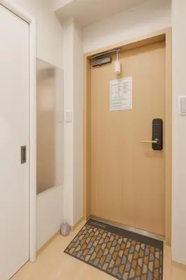 a door with a mat in front of it at \u8aa0\u5bb6 Makoto Hotel in Tokyo