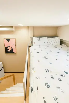 a bedroom with a bed with flowers and butterflies at \u8aa0\u5bb6 Makoto Hotel in Tokyo