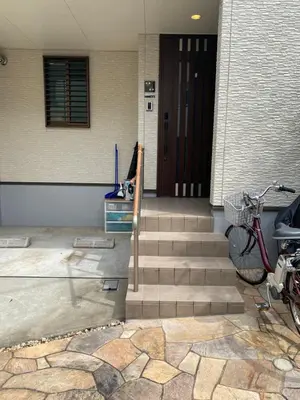 a staircase leading to a building with a door and a bike at Lily in Tokyo