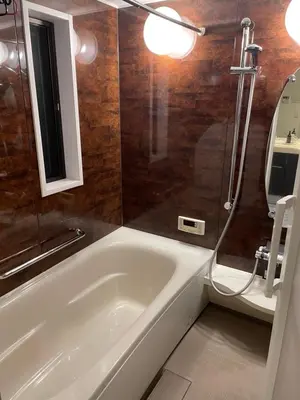 a bathroom with a white tub and a mirror at Lily in Tokyo