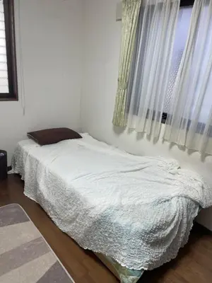 a white bed in a bedroom with a window at Lily in Tokyo