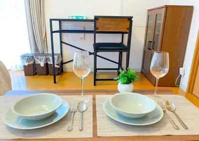 a table with two plates and two wine glasses at Walk to JR Shinjuku - Grand Écru II 605 - Balcony & Kitchen in Tokyo