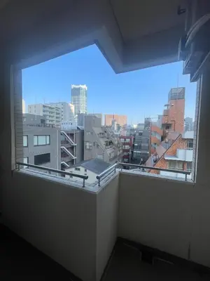 a large window in a room with a view of a city at Walk to JR Shinjuku - Grand Écru II 605 - Balcony & Kitchen in Tokyo