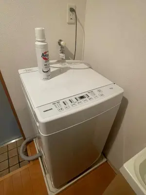 a washing machine with a bottle on top of it at Walk to JR Shinjuku - Grand Écru II 605 - Balcony & Kitchen in Tokyo
