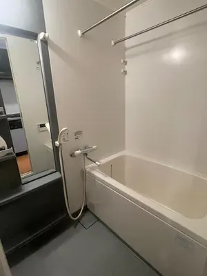 a bathroom with a bath tub and a mirror at Walk to JR Shinjuku - Grand Écru II 605 - Balcony & Kitchen in Tokyo