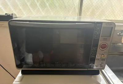 a microwave oven sitting on top of a counter at RHK Guest House102 in Tokyo