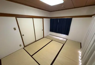 an empty room with white cabinets and a window at RHK Guest House102 in Tokyo