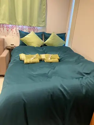 a blue bed with two towels on it at Park side tango in Tokyo