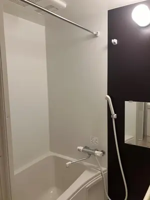 a shower in a bathroom with a tub and a mirror at Park side tango in Tokyo