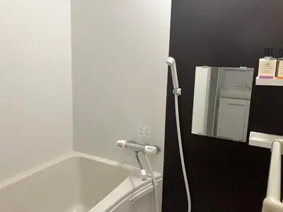 a bathroom with a hose hooked up to a mirror at Park side tango in Tokyo