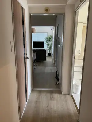 a hallway leading to a living room with a desk at \u30a2\u30f3\u30c9\u30b9\u30c6\u30a4\u592a\u5b50\u58022\u4e01\u76ee in Tokyo