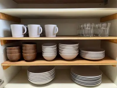 a shelf filled with plates and cups and bowls at \u30a2\u30f3\u30c9\u30b9\u30c6\u30a4\u592a\u5b50\u58022\u4e01\u76ee in Tokyo