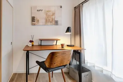 a home office with a wooden desk and a chair at \u3059\u307f\u308c\u306e\u5bbf in Tokyo