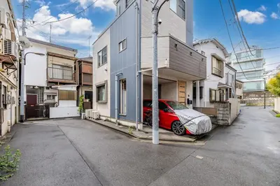 a red car parked in front of a building at \u3059\u307f\u308c\u306e\u5bbf in Tokyo