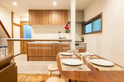 a kitchen and dining room with a wooden table at Shibuya House in Tokyo