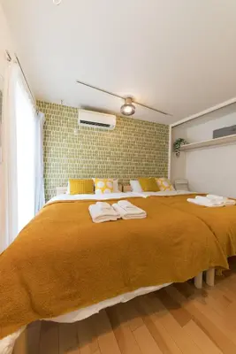 a bedroom with a large bed with towels on it at ORIENS SHIBUYA Stylish Apt - Steps to Scramble crossing - Foodie hub Ebisu & Daikanyama in Tokyo