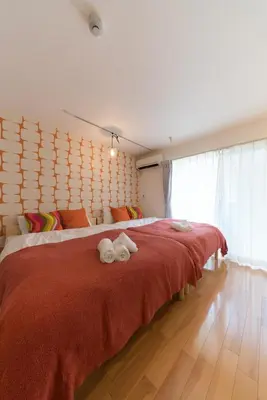 a bedroom with a large bed with towels on it at ORIENS SHIBUYA Stylish Apt - Steps to Scramble crossing - Foodie hub Ebisu & Daikanyama in Tokyo