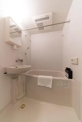 a white bathroom with a sink and a bath tub at ORIENS SHIBUYA Stylish Apt - Steps to Scramble crossing - Foodie hub Ebisu & Daikanyama in Tokyo