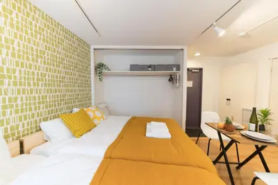 a bedroom with a bed and a table in it at ORIENS SHIBUYA Stylish Apt - Steps to Scramble crossing - Foodie hub Ebisu & Daikanyama in Tokyo