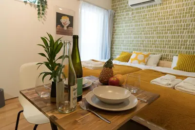 a table with a plate of food on top of it at ORIENS SHIBUYA Stylish Apt - Steps to Scramble crossing - Foodie hub Ebisu & Daikanyama in Tokyo