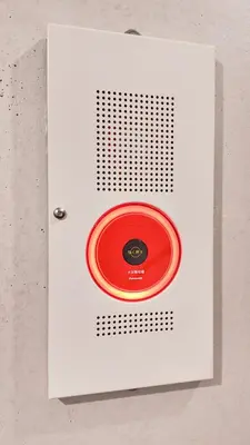a white box with a red lid on a wall at 9Stay Bunkyo Otsuka in Tokyo