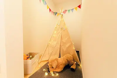 a stuffed elephant laying on the floor next to a tent at Zen Luxe in Tokyo