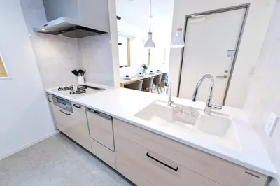 a white kitchen with a sink and a mirror at Zen Luxe in Tokyo