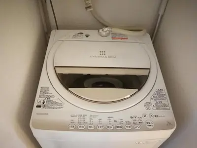 a white toilet in a bathroom with its lid up at \u611b\u306e\u5c4b\u6c11\u6cca\u65b0\u5bbf in Tokyo
