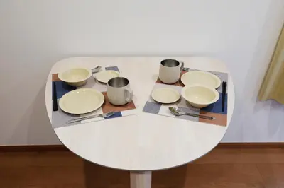 a white table with plates and utensils on it at Life Town Shinkoiwa - Akihabara Direct Access - 7mins walk from sta in Tokyo