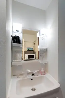 a bathroom with a sink and a microwave at Life Town Shinkoiwa - Akihabara Direct Access - 7mins walk from sta in Tokyo