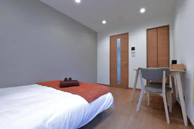 a bedroom with a bed and a desk and a chair at Life Town Shinkoiwa - Akihabara Direct Access - 7mins walk from sta in Tokyo
