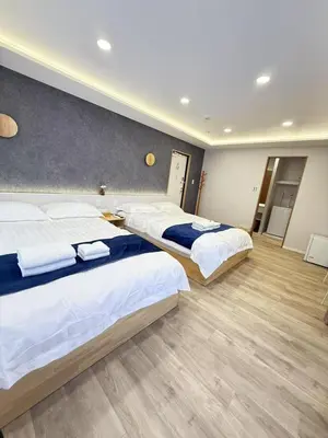 a hotel room with three beds in it at \u6d45\u8349\u99c5\u5f92\u6b698\u5206 \u6d45\u8349\u5bfa\u3059\u3050\u305d\u3070\u306e\u4ef2\u898b\u4e16\u6563\u7b56\u30b9\u30c6\u30a4 DqcEoY in Tokyo