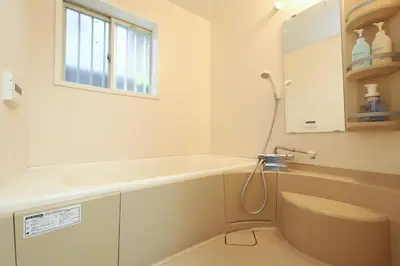 a bathroom with a tub and a toilet and a window at Omorinishi 3chome House in Tokyo