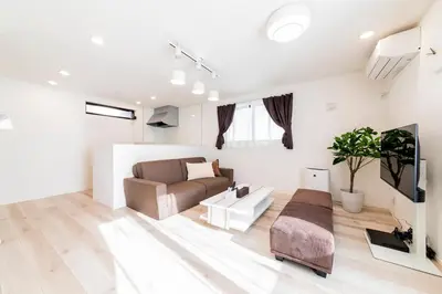 a living room with a couch and a table at Akabanenishi 3chome House in Tokyo