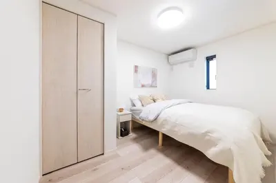 a bedroom with a bed and a closet at Akabanenishi 3chome House in Tokyo
