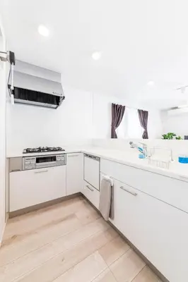 a white kitchen with white cabinets and a sink at Akabanenishi 3chome House in Tokyo