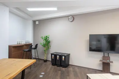 a meeting room with a large flat screen tv on a wall at Tomihisa House in Tokyo