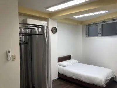 a bedroom with a bed and a shower in it at Tomihisa House in Tokyo
