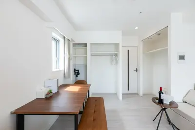 a living room with a wooden table and a couch at LIVCITY Kinshicho 1101 Skytree view in Tokyo