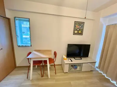 a small living room with a table and a television at YMK Oshiage 7B in Tokyo