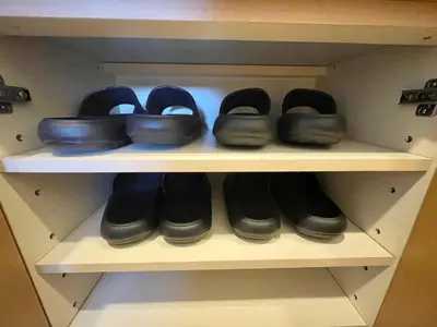 a row of shoes on a shelf in a closet at YMK Oshiage 7B in Tokyo