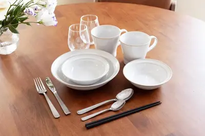 a wooden table with plates and silverware on it at \u3077\u3075\u304b\u767d\u9b1a in Tokyo
