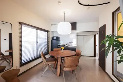 a dining room with a wooden table and chairs at \u3077\u3075\u304b\u767d\u9b1a in Tokyo