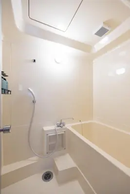 a white bathroom with a tub and a shower at \u3077\u3075\u304b\u767d\u9b1a in Tokyo