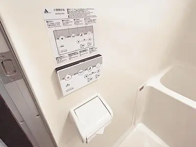 a bathroom with a toilet and a sign on the wall at Tokyo Stay West Sugamo #102 in Tokyo