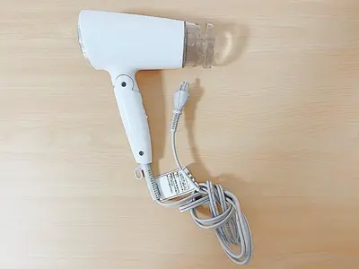 a white hair dryer attached to a wooden table at Tokyo Stay West Sugamo #102 in Tokyo