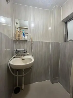 a bathroom with a sink and a mirror at MW Hotel in Tokyo