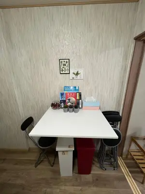 a white table in a room with chairs at MW Hotel in Tokyo